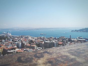 Aerial view of town by sea against clear sky