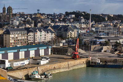 High angle view of cityscape by sea against sky