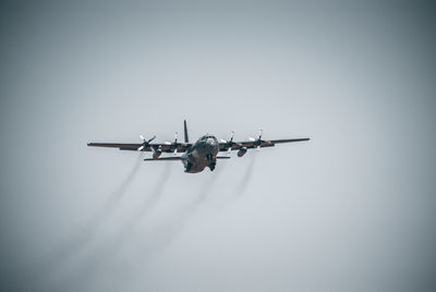 Low angle view of airplane flying against clear sky