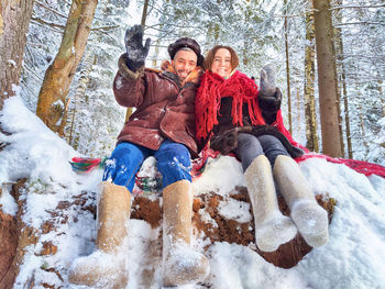 Friends sitting on snow