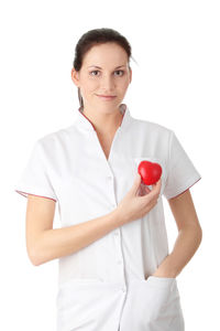 Portrait of a smiling young woman against white background