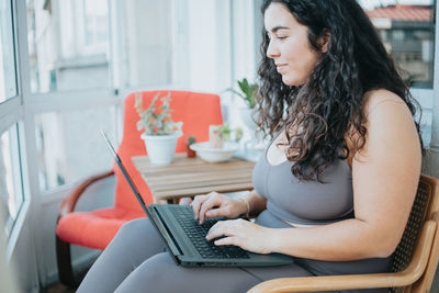 Young woman using laptop at home