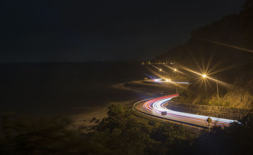 High angle view of light trails on road at night