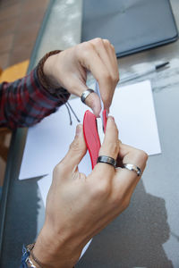 Cropped hands of woman stapling paper