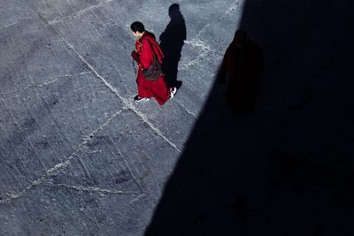 High angle view of man with red umbrella