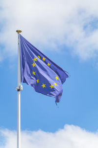 Low angle view of flag against sky