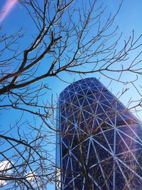 Low angle view of bare tree against clear blue sky