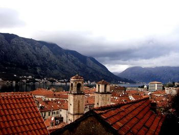 Kotor by sea and mountains against sky