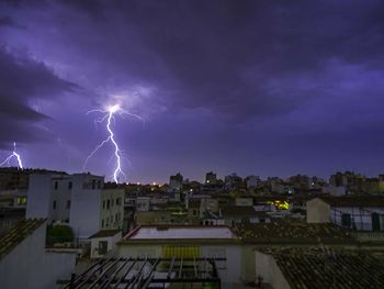 Lightning over buildings in city at night