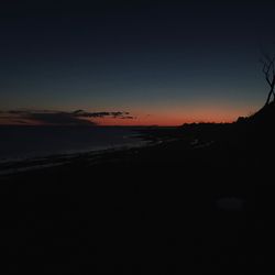 Scenic view of sea against clear sky at sunset