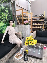 High angle view of woman sitting by potted plants