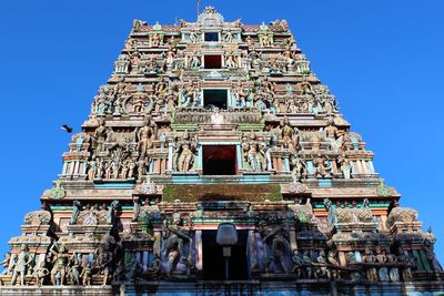 Low angle view of statue against blue sky