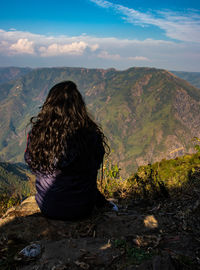 Rear view of woman looking at mountains