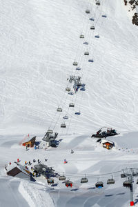 Top view of the two branches of the chairlift. the slope below the cable car with traces of skis