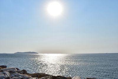 Scenic view of sea against clear sky on sunny day