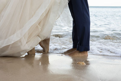 Low section of couple standing on floor