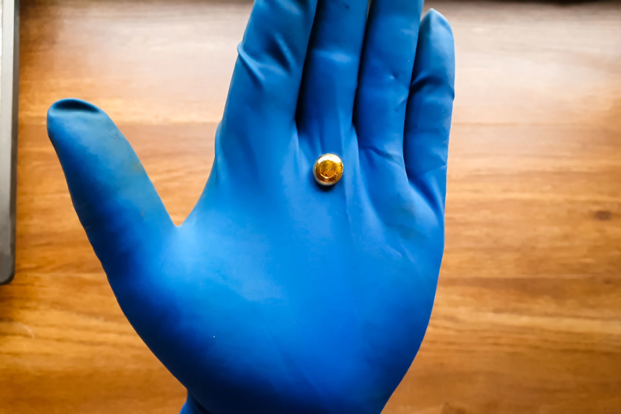 CLOSE-UP OF WOMAN HOLDING BLUE UMBRELLA WITH BALL