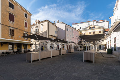 Houses by street in town against sky