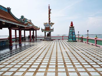 View of gazebo by sea against sky