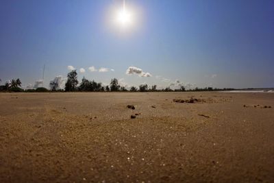 Scenic view of beach against bright sky