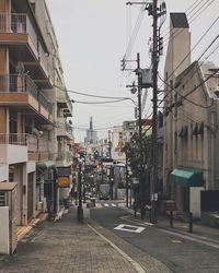 Street amidst buildings in city against sky