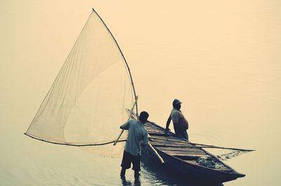 Men with fishing boat in the sea