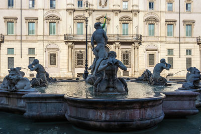 Statue against fountain