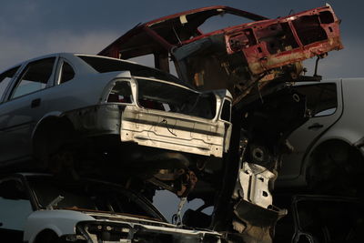 Stacked abandoned cars at junkyard