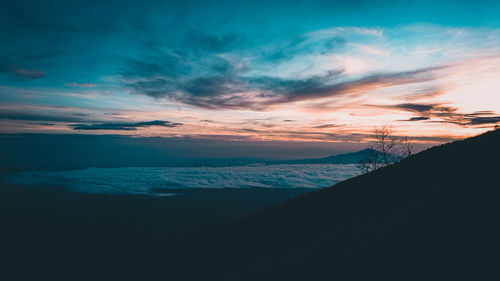 Scenic view of silhouette mountain against dramatic sky