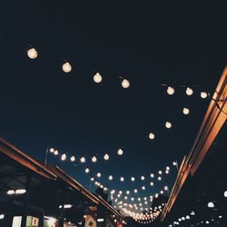 Low angle view of illuminated lights at night