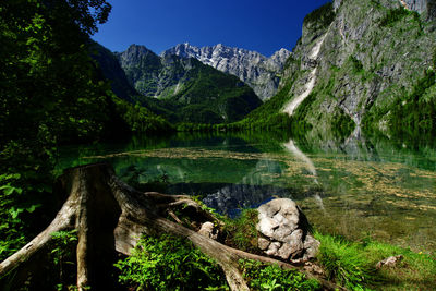 Scenic view of lake and mountains against sky