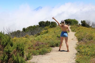 Full length of young woman standing in park