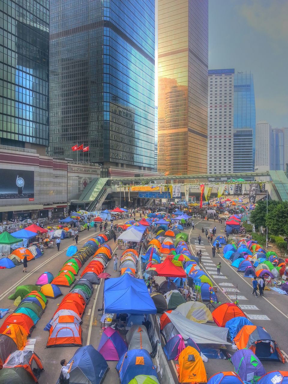 architecture, building exterior, built structure, city, multi colored, street, building, city life, graffiti, men, lifestyles, large group of people, leisure activity, person, outdoors, day, incidental people, modern, office building