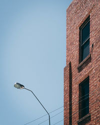 Low angle view of street light against sky