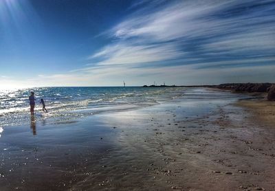 Man standing on beach against sky