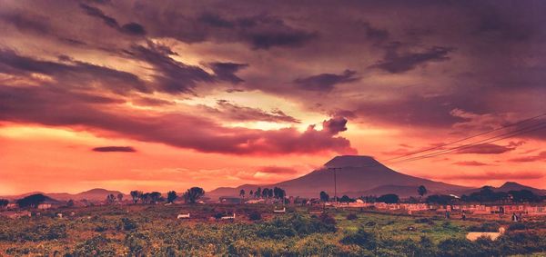 Scenic view of dramatic sky over landscape during sunset