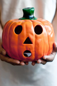 Close-up of woman hand holding jack o lantern during halloween