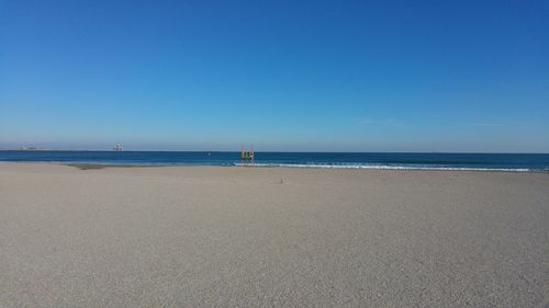 Scenic view of sea against clear blue sky