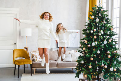 Woman with christmas tree at home