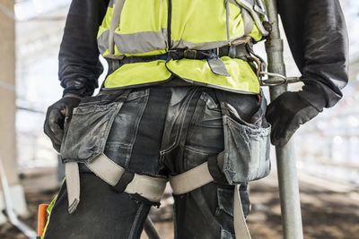 Midsection of construction worker at site