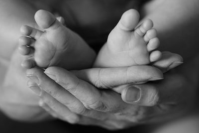 Close-up of baby feet in morhers hands