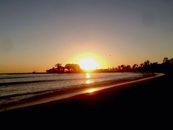 Scenic view of sea against clear sky during sunset