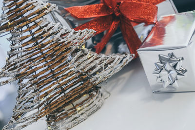 Gift boxes near christmas tree inside home. box with holiday ribbon with bows. festive atmosphere