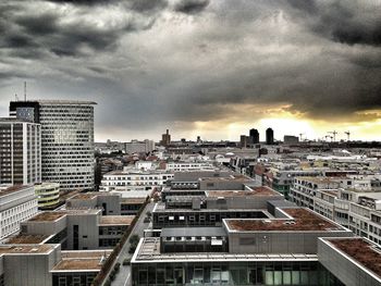 Low angle view of buildings against cloudy sky