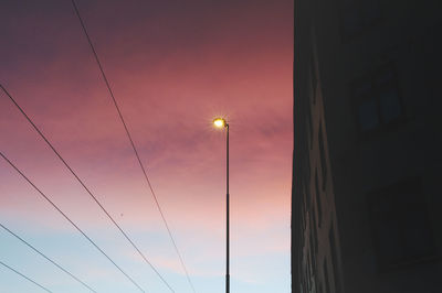 Low angle view of illuminated street light against sky