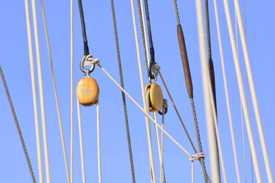 Low angle view of cables against clear blue sky