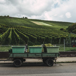 Vintage car on agricultural field against sky