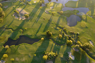 Aerial photographic documentation of a golf course taken at sunset