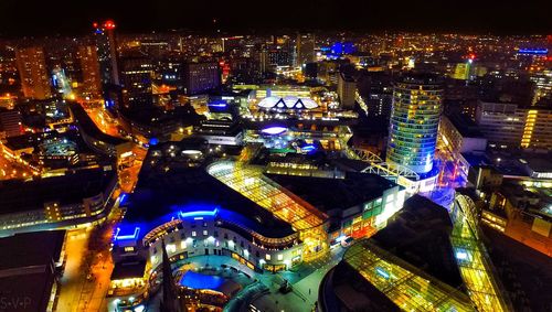 Aerial view of city lit up at night