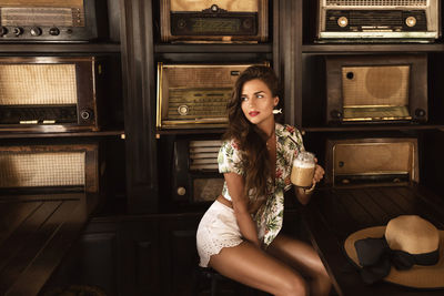 Portrait of young woman sitting at home